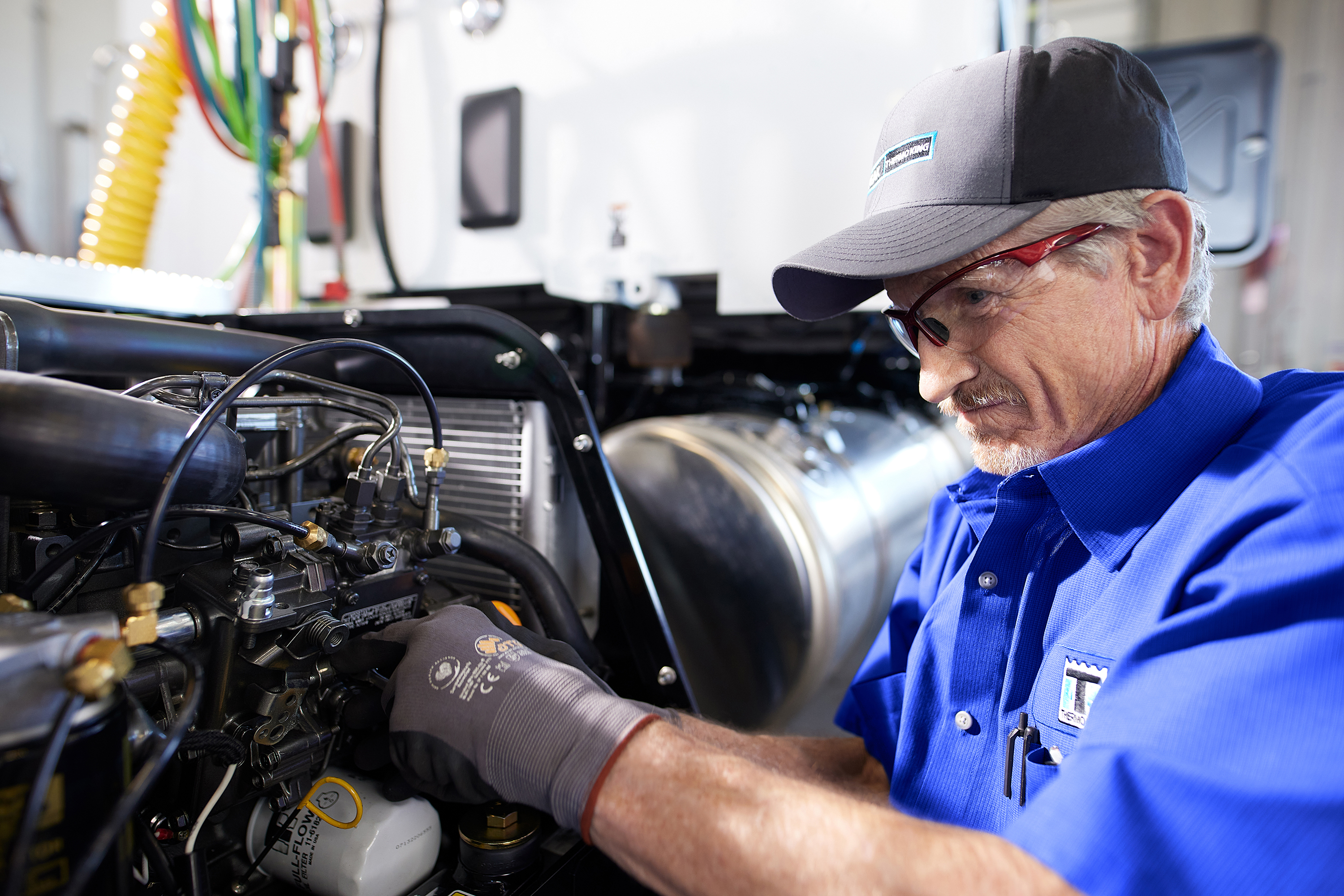 Male service technician in hat working on equipment